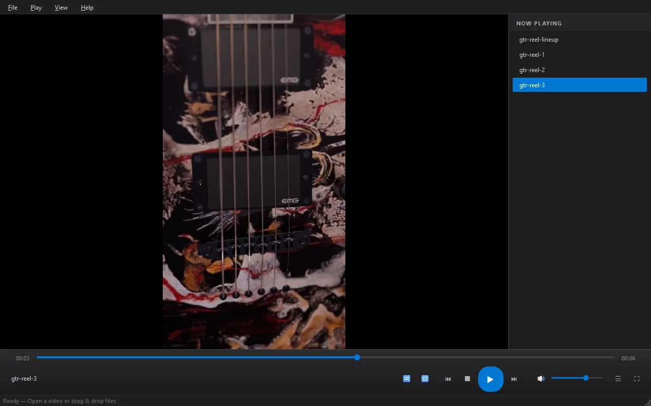 Flux Player paused on a close-up of guitar pickups and a painted body